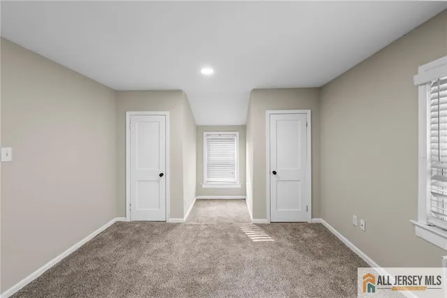 a view of an empty room and a window