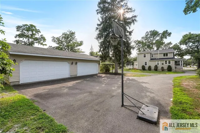 a view of a house with a yard and garage