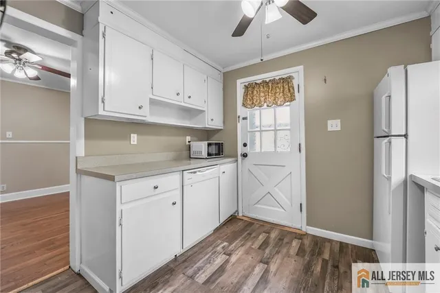 a kitchen with cabinets appliances and a window