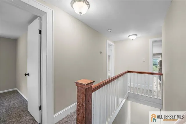 a view of a hallway with stairs