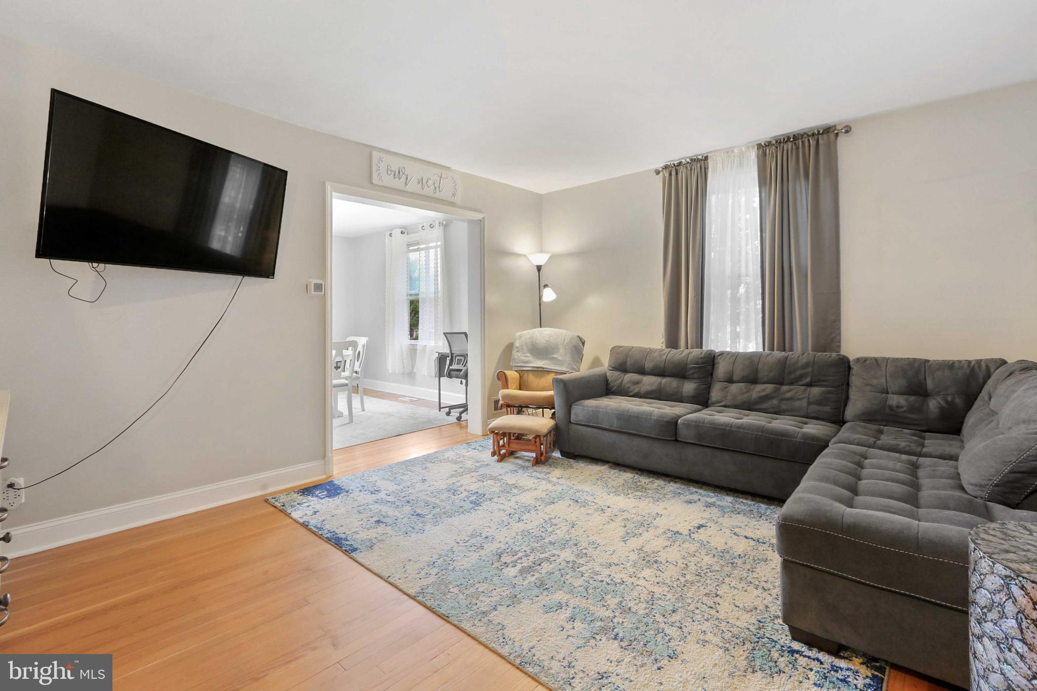 215 Cherrydell Road Catonsville, MD 21228 - Photo 6 of 20 a living room with a couch and a flat screen tv