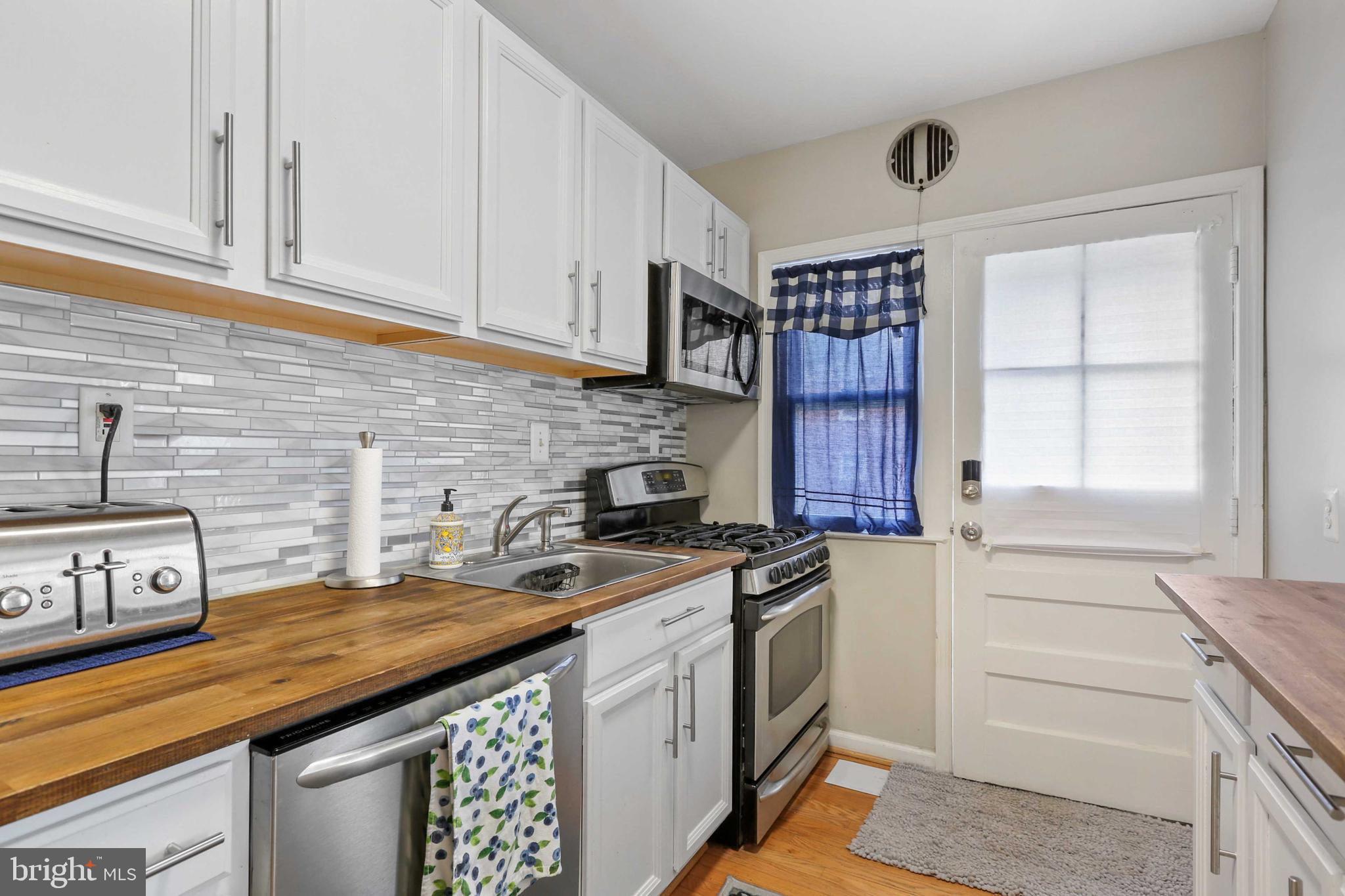215 Cherrydell Road Catonsville, MD 21228 - Photo 7 of 20 a kitchen with stainless steel appliances granite countertop a stove and a cabinets