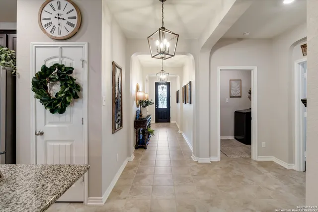 a view of a hallway with chandelier
