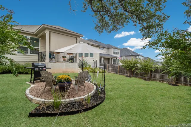 a view of a house with backyard porch and sitting area