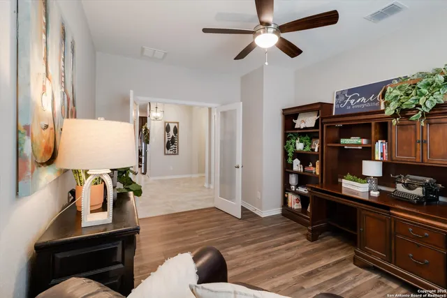 a living room with furniture and wooden floor
