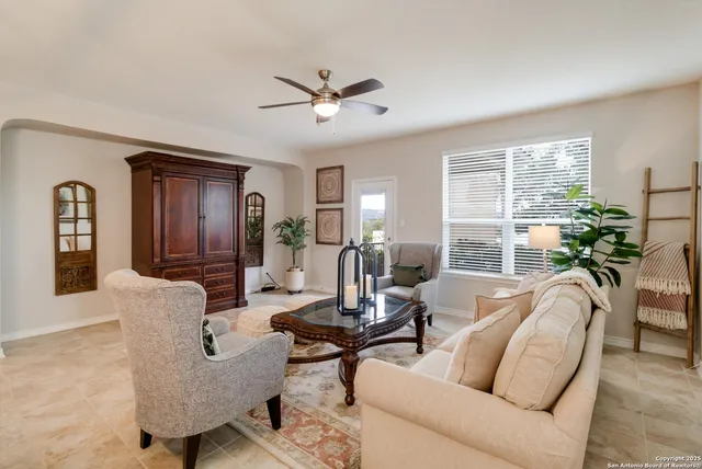 a living room with furniture and a large window
