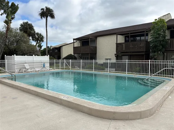 a view of a swimming pool with a yard