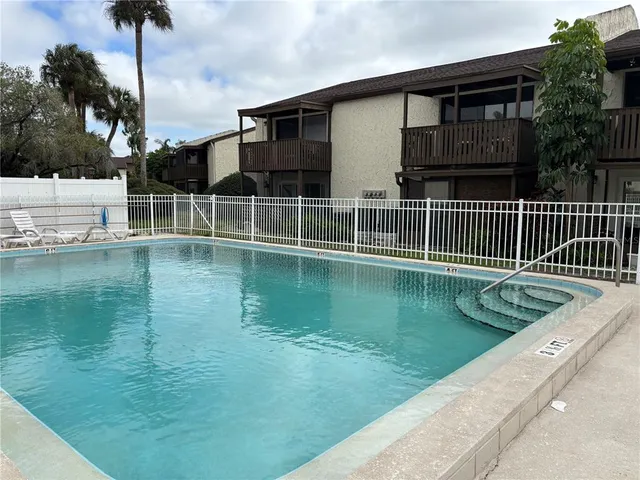 a view of house with swimming pool yard and outdoor seating