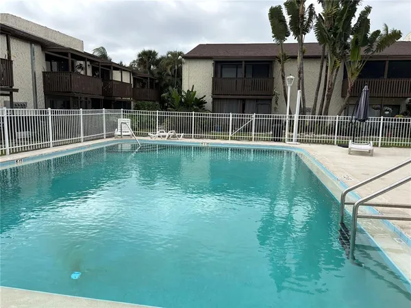 a view of a swimming pool with a house in the background