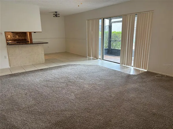 a view of a kitchen with a sink and a large window