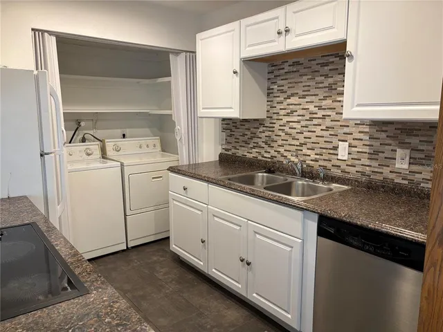 a kitchen with sink and cabinets