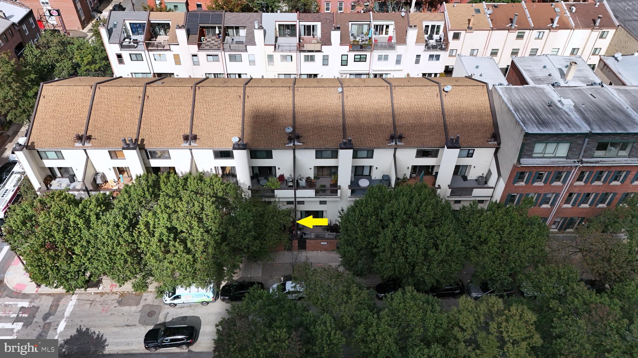 2033 Arch Street, Unit DR5L Philadelphia, PA 19103 - Photo 5 of 5 a view of a tall building with a couple of cars parked in front of it