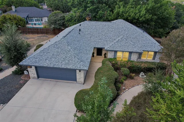 a aerial view of a house with a yard and plants