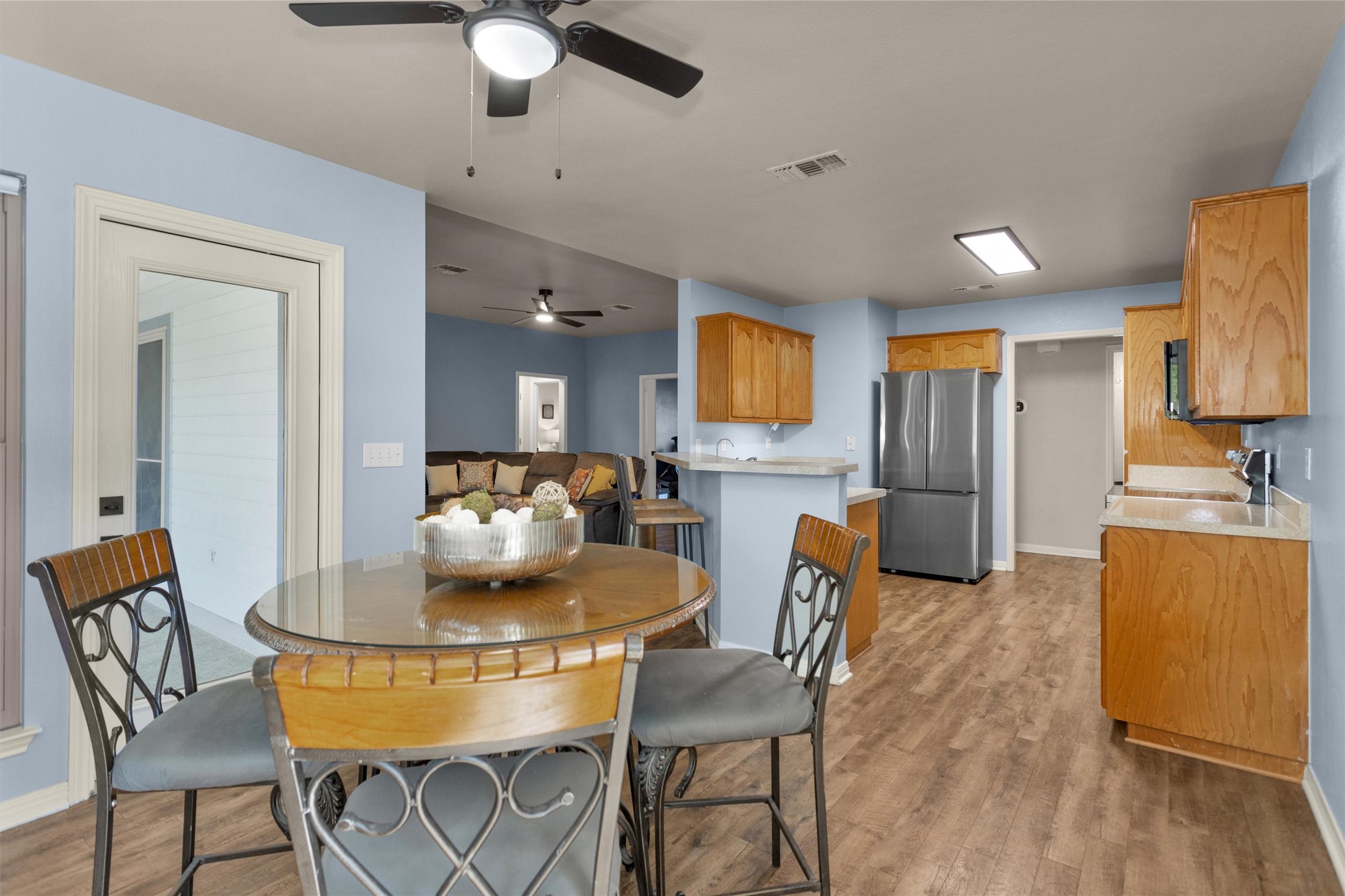 1906 Round Table New Braunfels, TX 78130 - Photo 11 of 46 a kitchen with stainless steel appliances kitchen island granite countertop a dining table chairs and a refrigerator