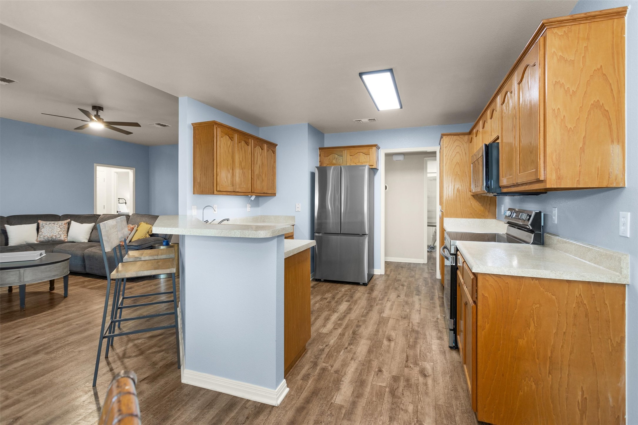 1906 Round Table New Braunfels, TX 78130 - Photo 13 of 46 a kitchen with stainless steel appliances granite countertop a refrigerator a stove and a wooden floors
