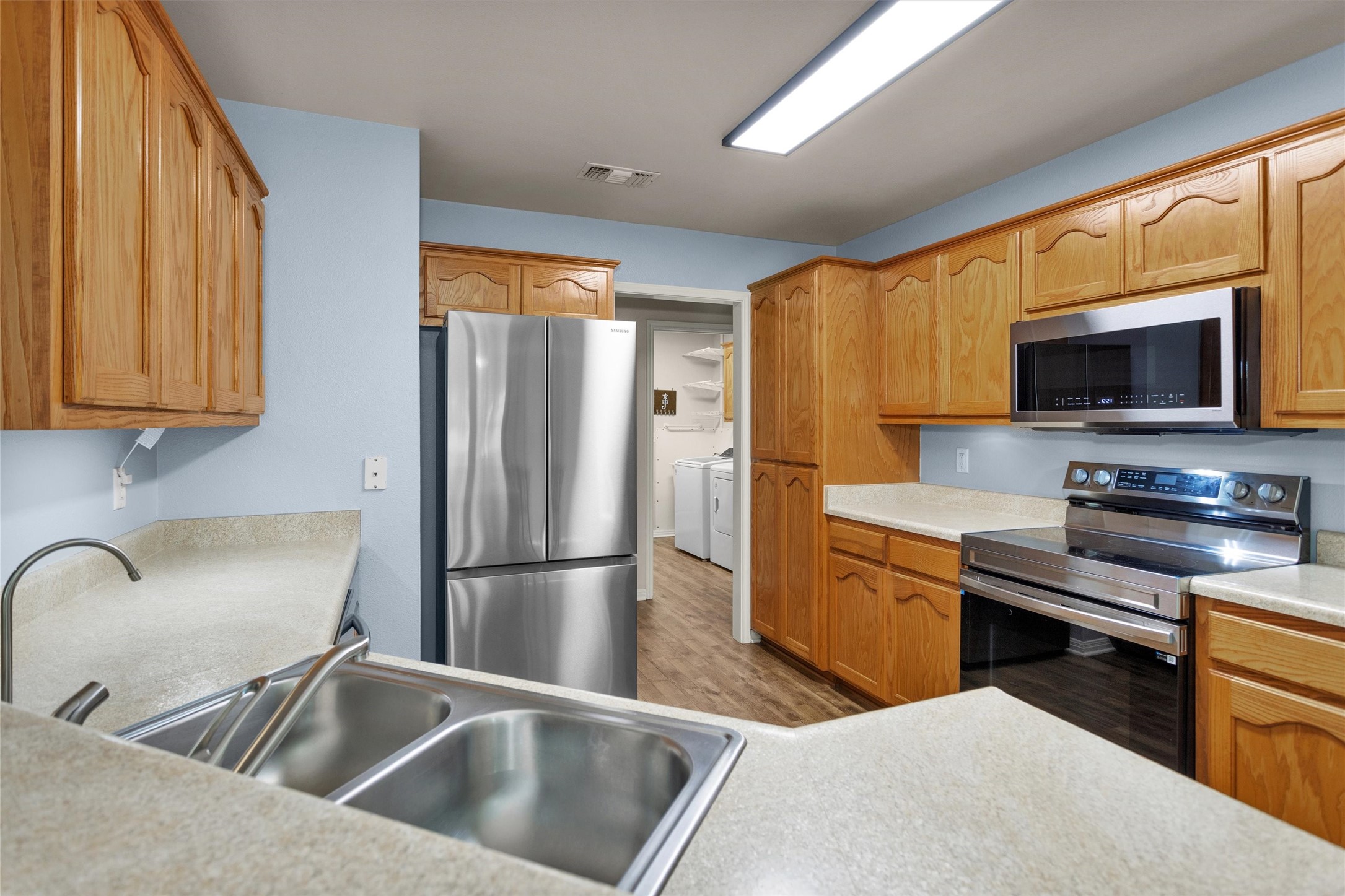 1906 Round Table New Braunfels, TX 78130 - Photo 17 of 46 a kitchen with stainless steel appliances a refrigerator sink and microwave