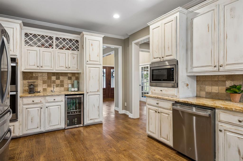 1700 Rock Ridge Road Lucas, TX 75002 - Photo 10 of 37 The kitchen is already spacious and functional, with stainless appliances, refrigerator and beverage frig, and coffee bar.