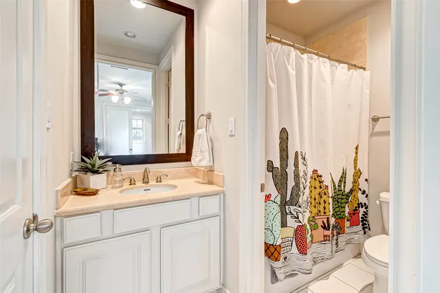 a bathroom with a toilet and a shower curtain