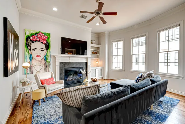 a living room with furniture and a fireplace