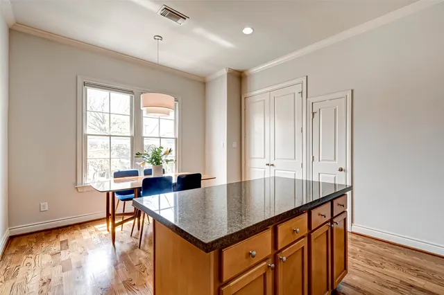 a dining room with furniture and wooden floor
