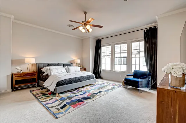 a bedroom with furniture and a flat screen tv