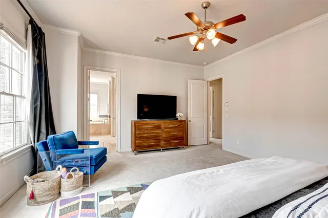 a bedroom with a bed lamp and a window