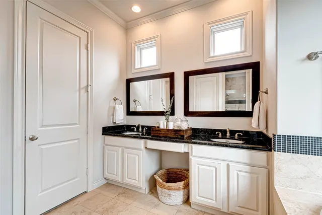 a bathroom with a granite countertop tub sink and mirror