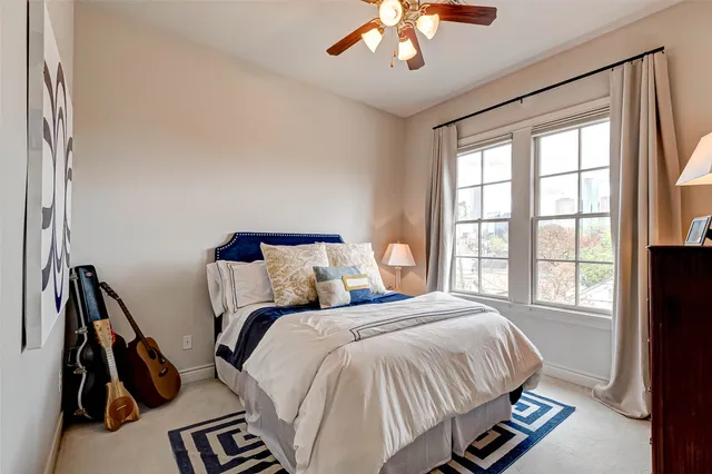 a bedroom with a bed and a dresser with mirror