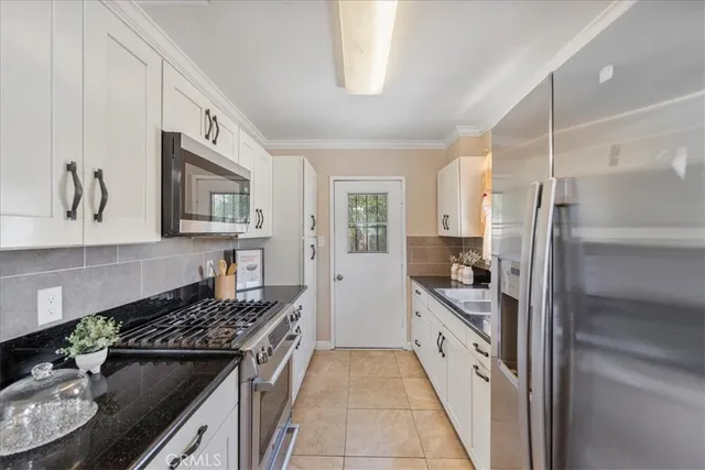 a kitchen with stainless steel appliances granite countertop a stove and a refrigerator