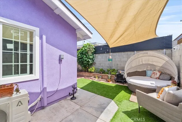 a front view of a house with a garden and outdoor seating