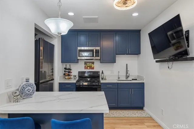 a kitchen with a refrigerator sink and microwave