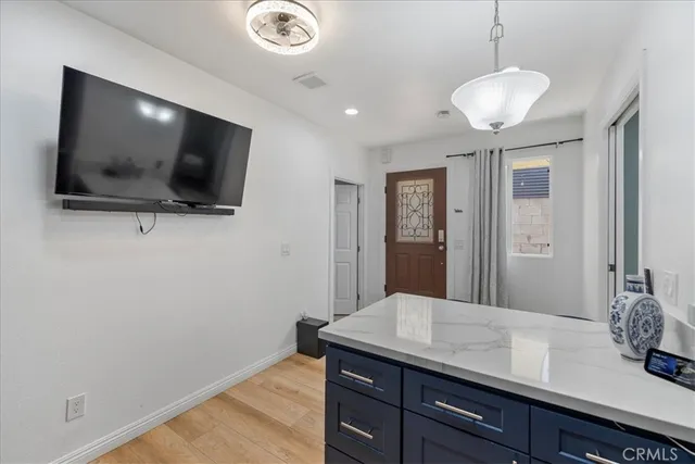a bedroom with a bed and a view of living room