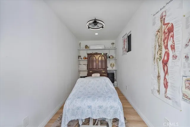 an aerial view of a house with a yard and seating space