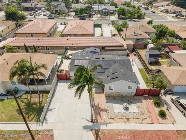 an aerial view of residential houses with outdoor space and parking