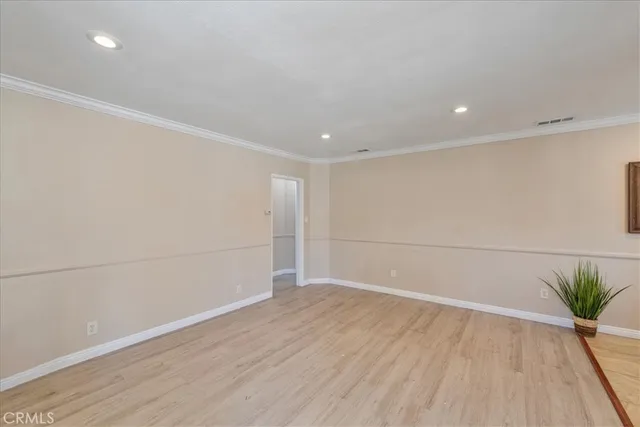 a view of a room with wooden floor