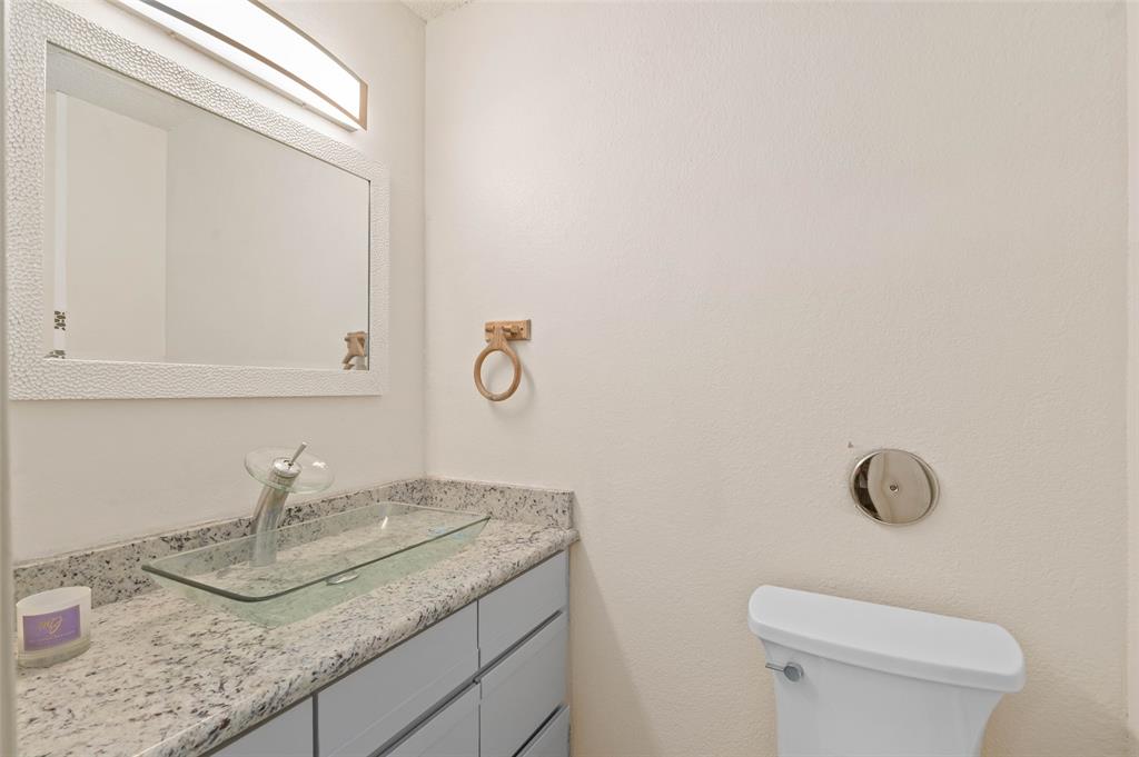 700 West Collins Street Denton, TX 76201 - Photo 7 of 36 Downstairs bathroom with granite countertops