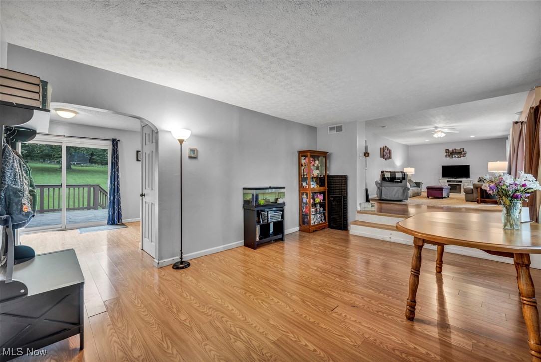 3954 Homestead Road Ravenna, OH 44266 - Photo 12 of 46 Living area featuring a ceiling fan, light wood finished floors, and a textured ceiling