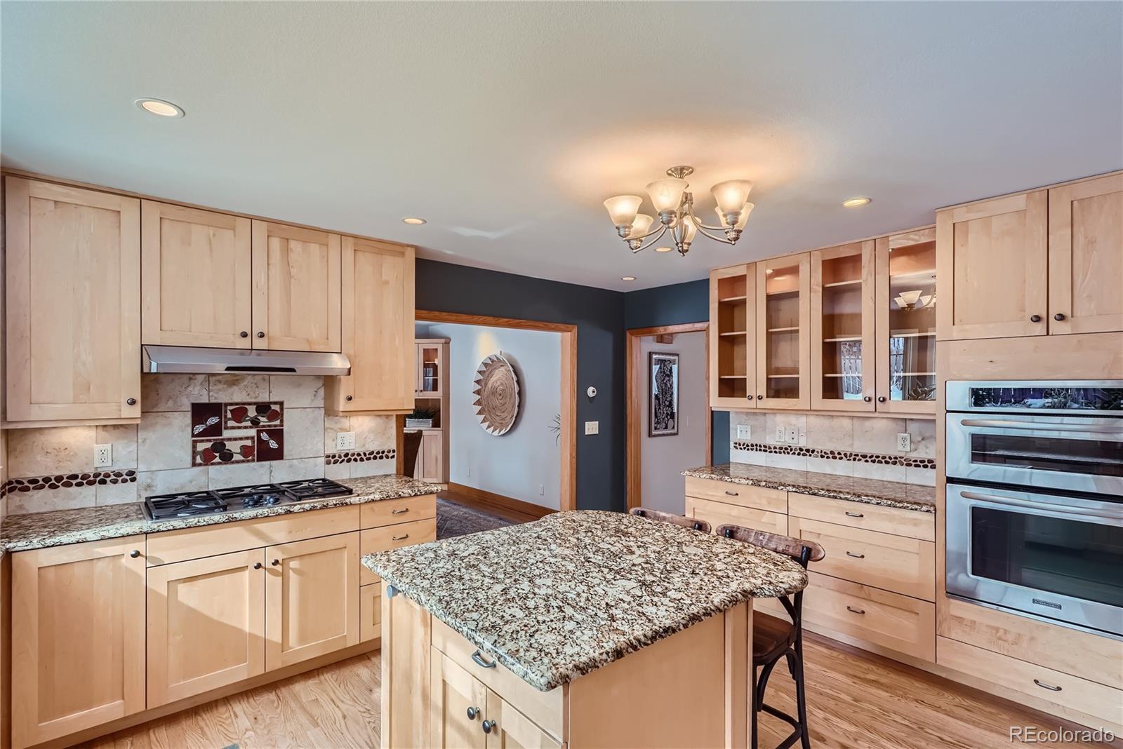 205 Fair Place Boulder, CO 80302 - Photo 12 of 46 a kitchen with stainless steel appliances granite countertop a stove top oven a refrigerator a sink and dishwasher with wooden floor