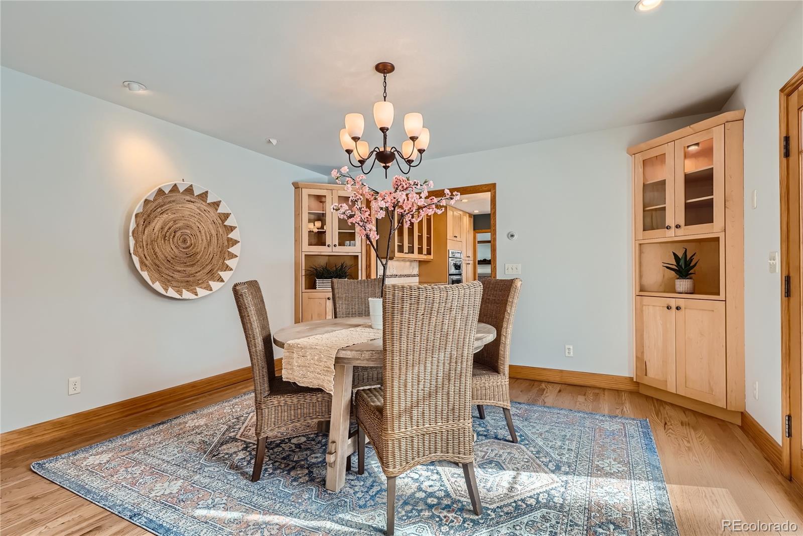 205 Fair Place Boulder, CO 80302 - Photo 14 of 46 a view of a dining room with furniture a chandelier and wooden floor