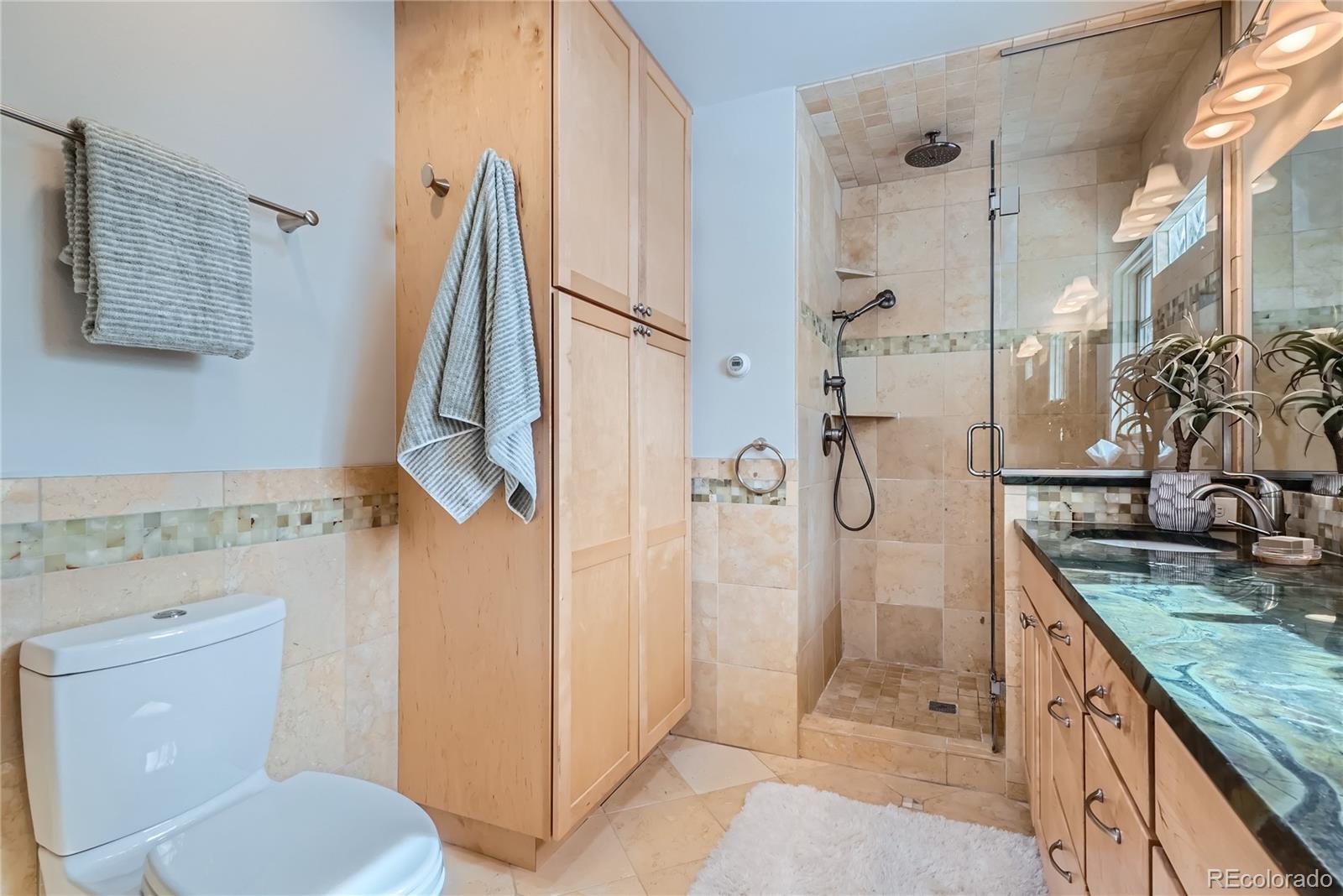 205 Fair Place Boulder, CO 80302 - Photo 23 of 46 a bathroom with a granite countertop sink toilet and shower