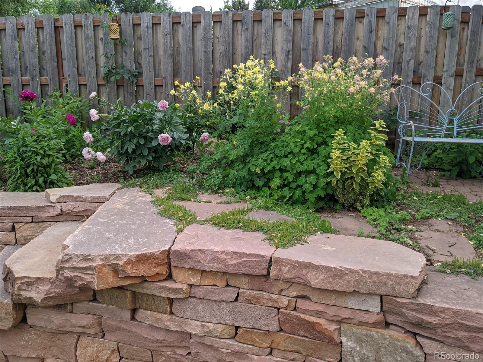 205 Fair Place Boulder, CO 80302 - Photo 33 of 46 a garden with flowers in front of it