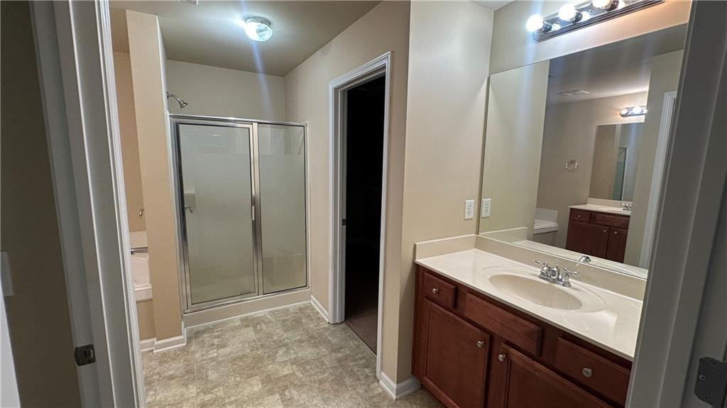 115 Tyson Woods Road Acworth, GA 30102 - Photo 15 of 23 a bathroom with a sink a mirror and a shower