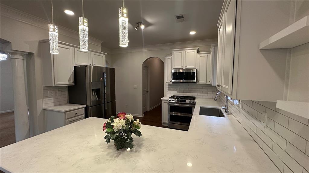 115 Tyson Woods Road Acworth, GA 30102 - Photo 4 of 23 a kitchen with stainless steel appliances a refrigerator sink and stove