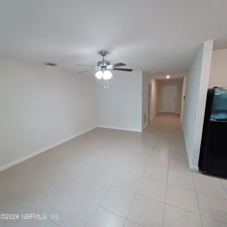 a view of a livingroom with a ceiling fan and window