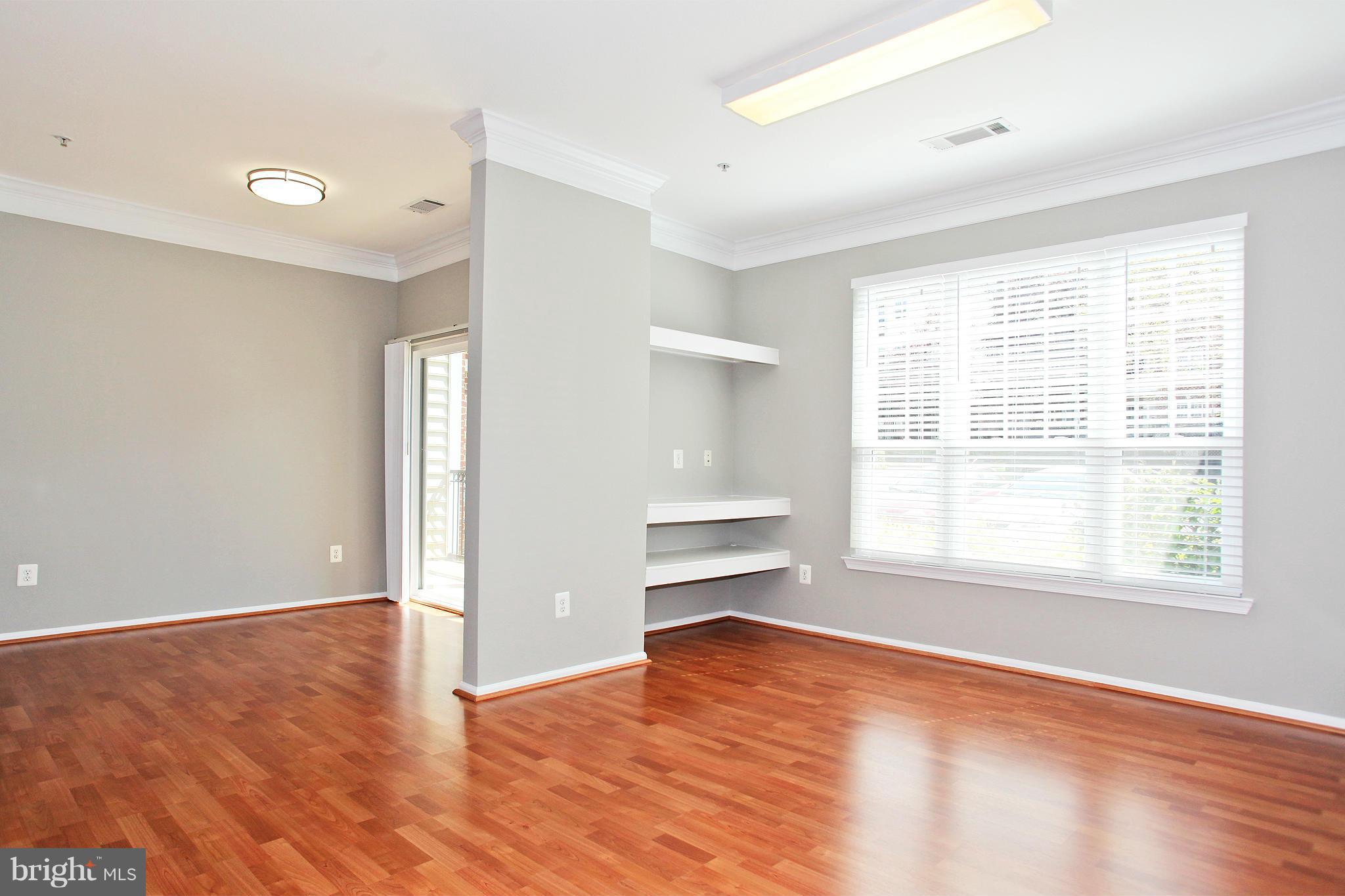 1530 Spring Gate Dr., Unit 9103 McLean, VA 22102 - Photo 2 of 30 an empty room with wooden floor and windows