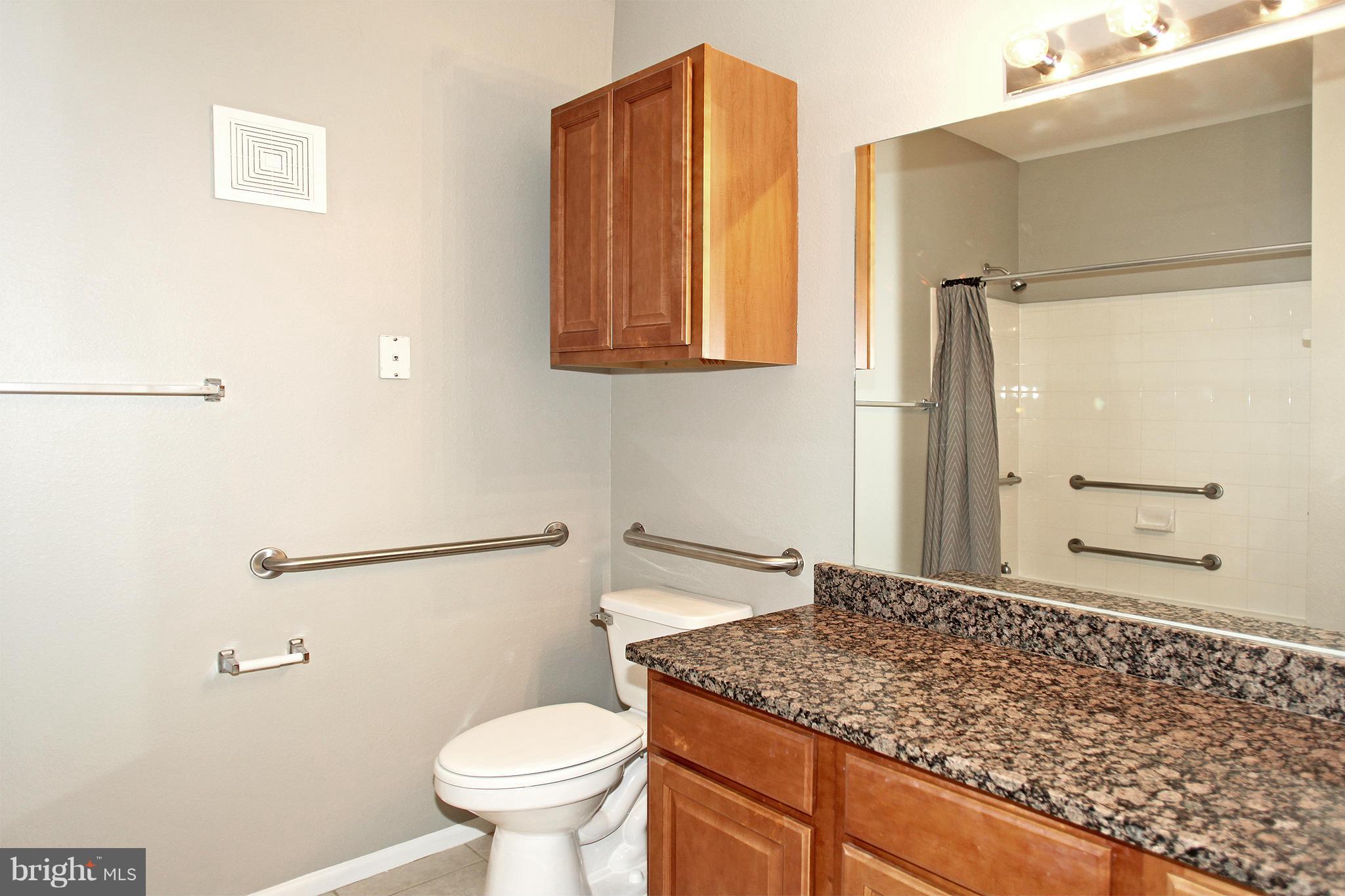 1530 Spring Gate Dr., Unit 9103 McLean, VA 22102 - Photo 13 of 30 a bathroom with a granite countertop sink toilet and shower
