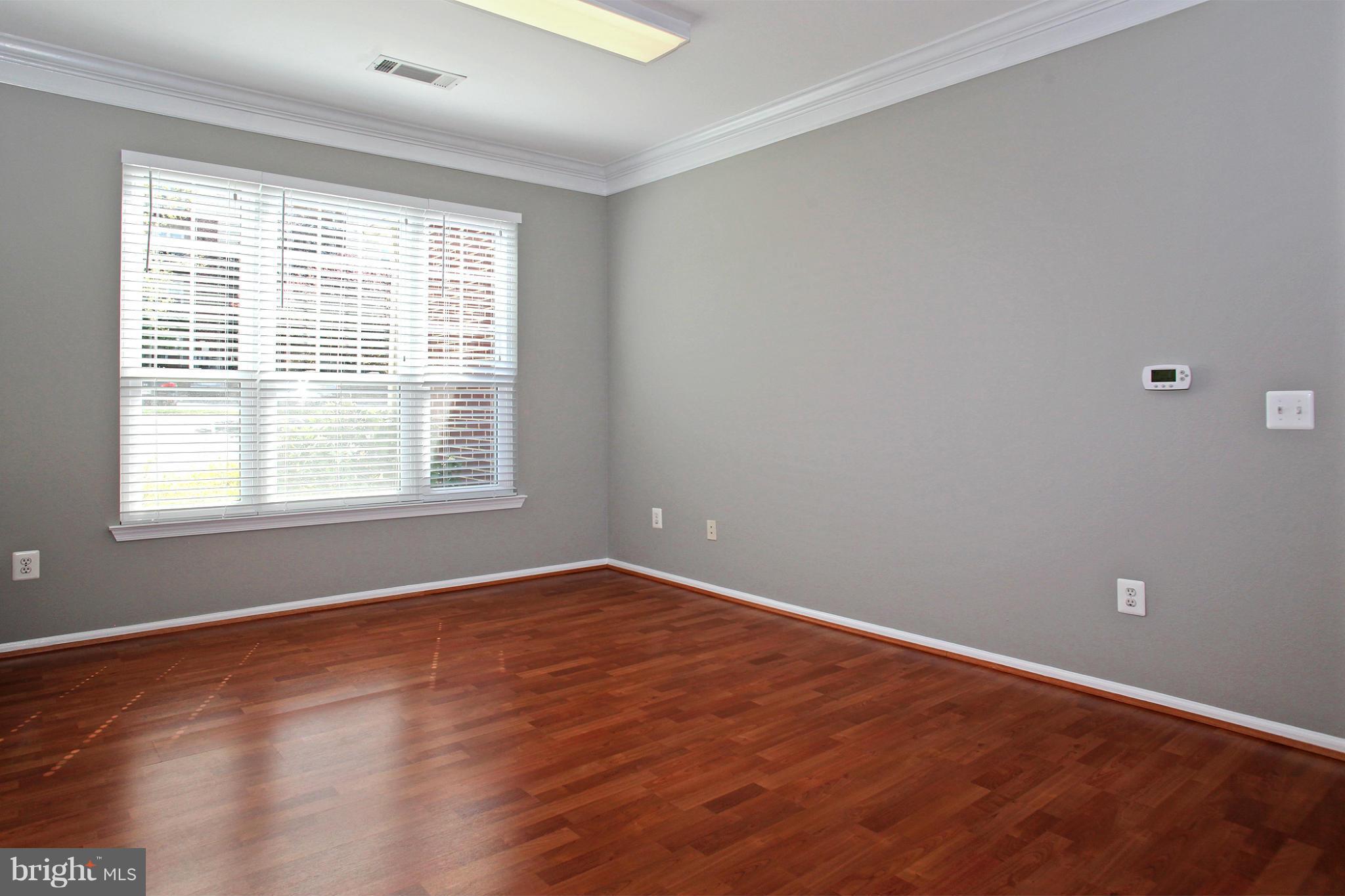 1530 Spring Gate Dr., Unit 9103 McLean, VA 22102 - Photo 17 of 30 a view of an empty room with wooden floor and a window
