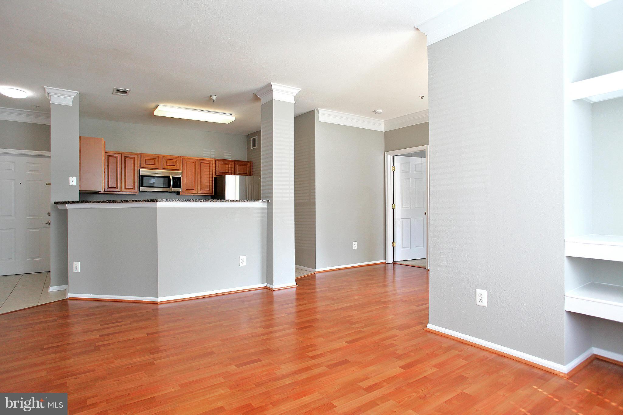 1530 Spring Gate Dr., Unit 9103 McLean, VA 22102 - Photo 3 of 30 a view of a kitchen with wooden floor and a sink