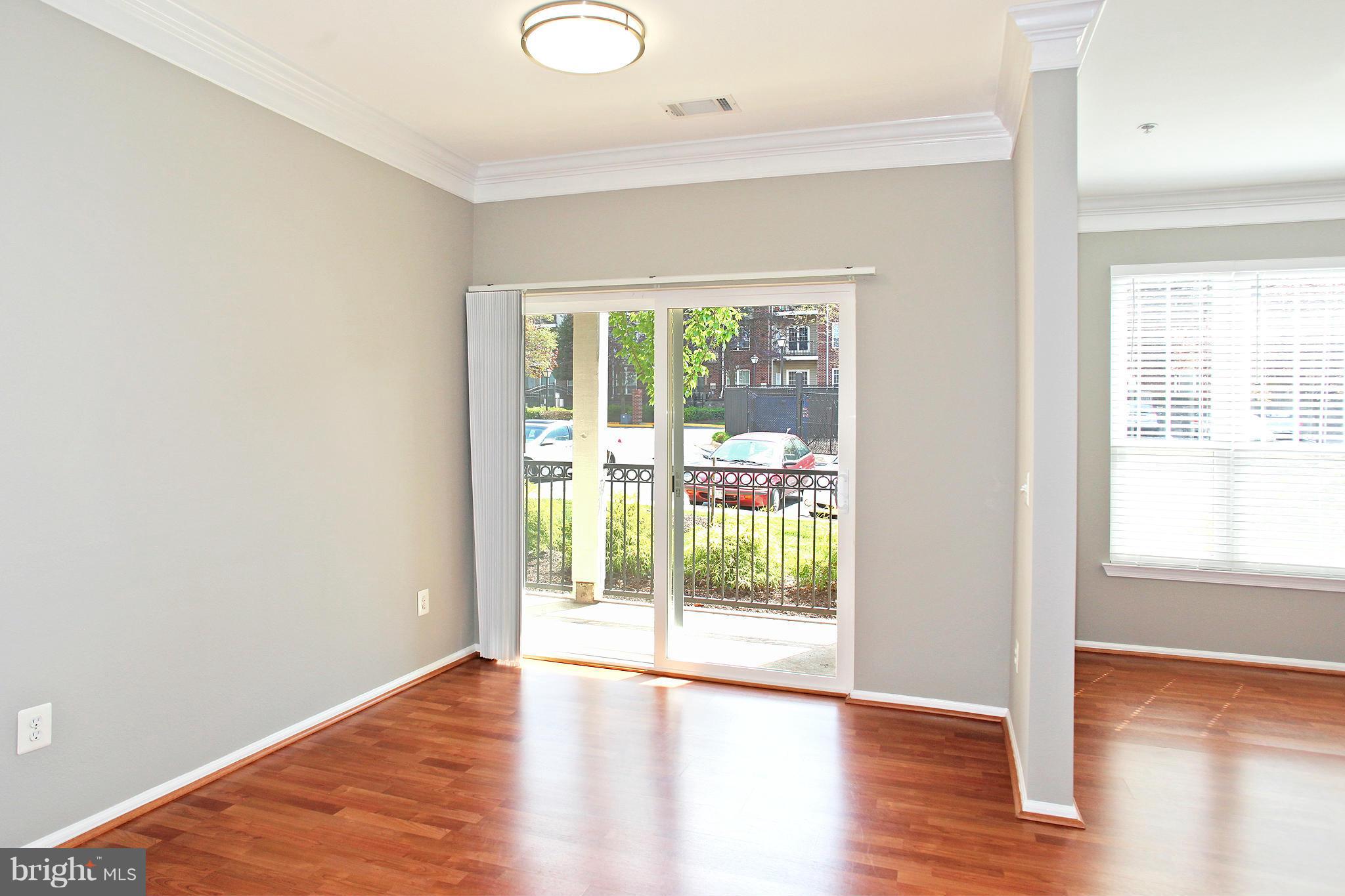 1530 Spring Gate Dr., Unit 9103 McLean, VA 22102 - Photo 8 of 30 a view of an empty room with wooden floor and a window
