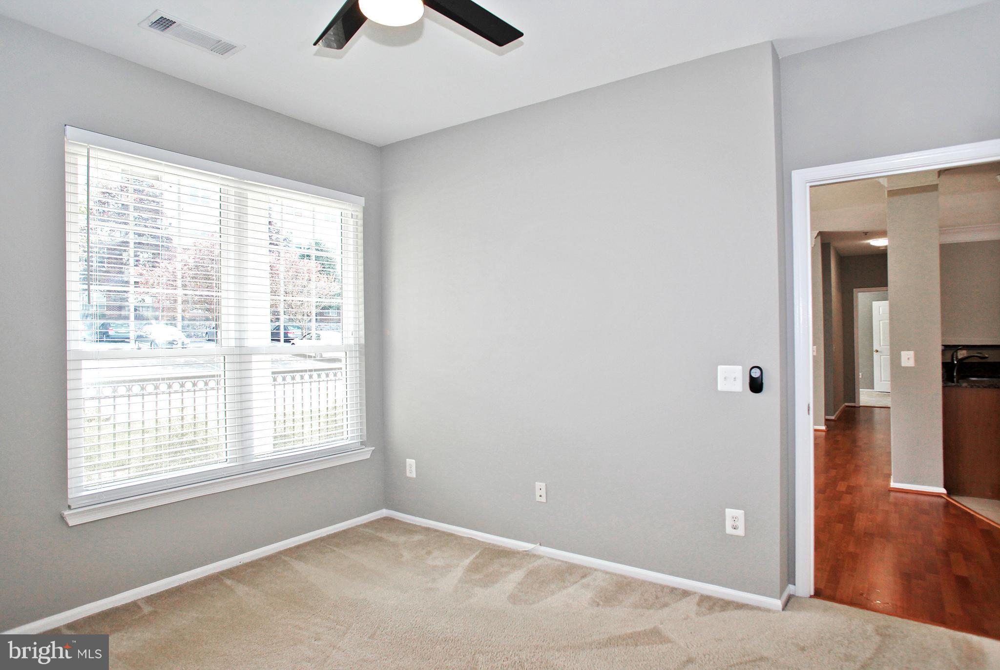 1530 Spring Gate Dr., Unit 9103 McLean, VA 22102 - Photo 9 of 30 a view of an empty room with window and wooden floor